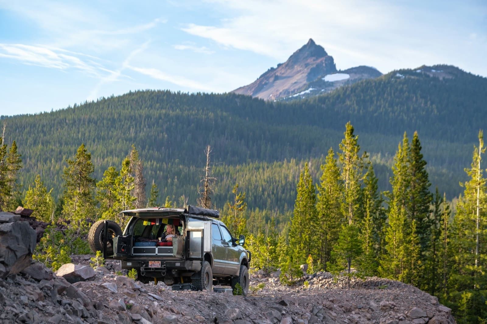 SUV below a volcanic peak